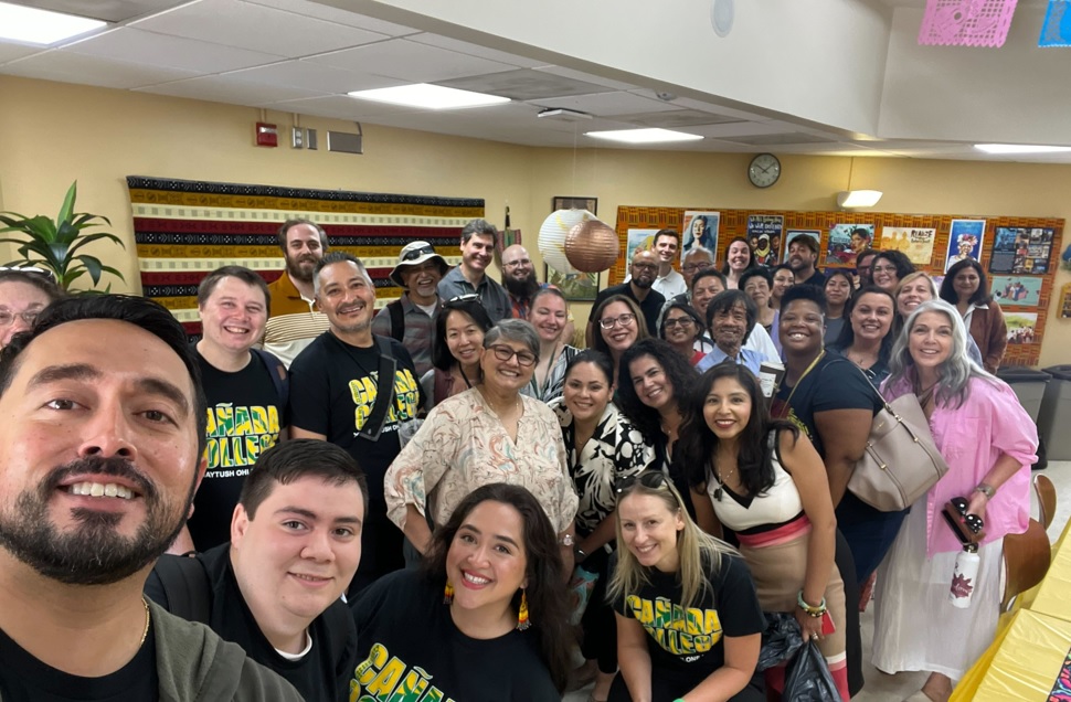 Group of 20 plus people smiling and taking a selfie in the cultural center location.